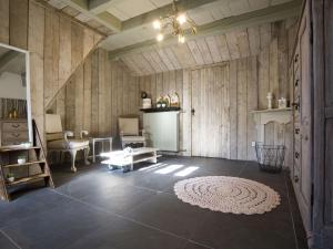 a living room with wood paneled walls and a fireplace at Boutique Holiday Home in Middelburg with Roof Terrace in Middelburg