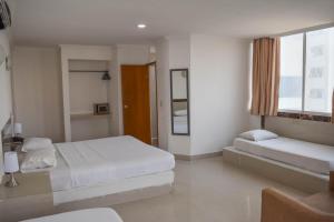 Postel nebo postele na pokoji v ubytování Hotel Cartagena Premium