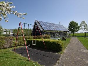 een schommel voor een huis met zonnepanelen bij Holiday home at the Kaagerplassen in Kaag