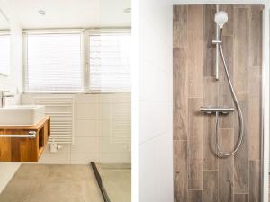 a bathroom with a shower and a sink at Sunny Bungalow in Heart of Texel in De Cocksdorp