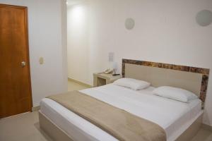 Postel nebo postele na pokoji v ubytování Hotel Cartagena Premium