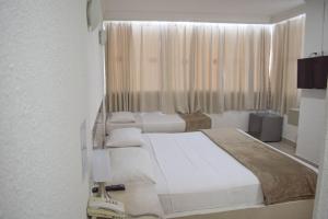 Postel nebo postele na pokoji v ubytování Hotel Cartagena Premium