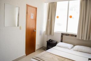 Postel nebo postele na pokoji v ubytování Hotel Cartagena Premium
