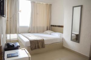Postel nebo postele na pokoji v ubytování Hotel Cartagena Premium
