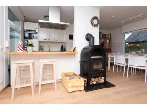 a kitchen with a stove in the middle of a room at Quiet location yet close to the beach and center large enclosed garden in Renesse