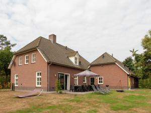 a house with a table and chairs in the yard at Luxurious holiday home in the middle of the Leenderbos nature reserve, near quiet Leende in Leende