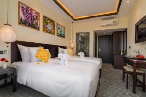 Hoi An Merrily De Art Hotel客房内的一张或多张床位