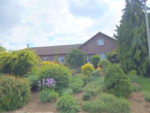 een huis met een tuin van bloemen en struiken bij Dreamy Holiday Home in Sweikhuizen in Spaubeek