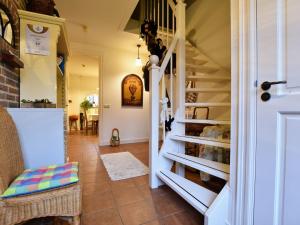 a hallway with a staircase leading up to a house at Spacious holiday farm in Bronckhorst with private garden in Bronkhorst