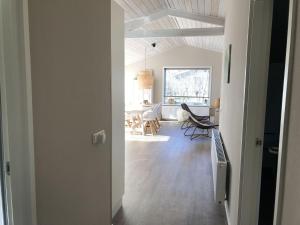 an open door to a room with a living room at bungalow situated directly at a large sand dunes in Ballum