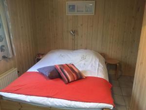 a bed with two pillows on it in a room at Secluded Holiday Home in Ballum Frisian Islands in Ballum