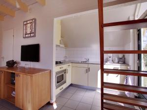 a kitchen with a bunk bed in a room at Tranquil Forest Retreat in Dalfsen