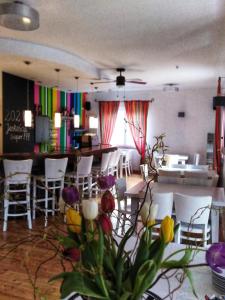 a room with chairs and a table with flowers at Pensjonat Willa w Parku in Polanica-Zdrój