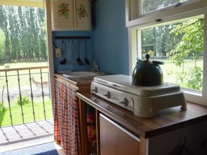 a kitchen with a stove with a pot on the counter at Holiday Home in Bergen op Zoom with Garden in Bergen op Zoom