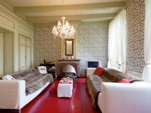 a living room with couches and a chandelier at Modern Farmhouse in Molkwerum near the Lake in Molkwerum