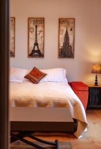 a bedroom with a bed and pictures on the wall at The Studio in Castle Bytham