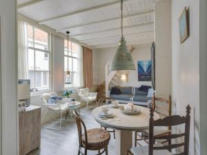 a living room with a table and a couch at Picturesque fisherman s house near the beach in Scheveningen