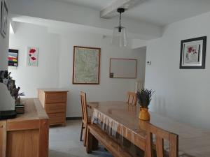 a dining room with a wooden table and chairs at Gîte Pilpoil in Sault-de-Vaucluse