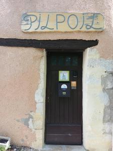 a door to a building with a sign above it at Gîte Pilpoil in Sault-de-Vaucluse