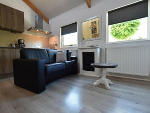 a living room with a couch and a table at Holiday home with wifi in Eerbeek