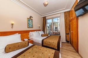 Postel nebo postele na pokoji v ubytování Santa Ottoman Hotel
