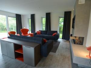 a living room with two couches and a fireplace at Luxury Villa in Texel with Private Garden in Westermient