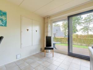 sala de estar con silla y ventana grande en Serene Holiday Home in Gaasterl n Sleat, en Sondel