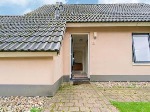 a small house with a door and a pathway at Serene Holiday Home in Gaasterl n Sleat in Sondel