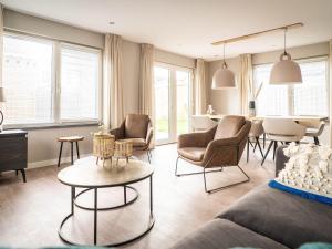 a living room with chairs and a table at Modern Holiday Home in De Cocksdorp in De Cocksdorp