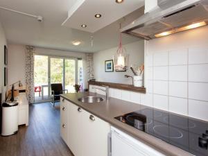 a kitchen with a sink and a counter at Apartment near the sea in Hollum in Hollum