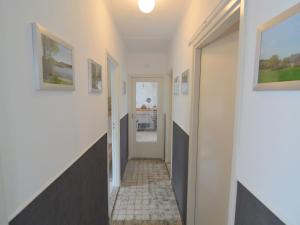 a hallway of a house with white walls at Quaint Holiday Home in Koewacht in Nieuwemolen