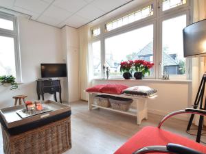 a living room with windows and a couch and a table at Apartment in Bergen near Sandy Beaches in Bergen