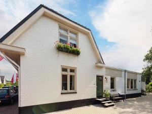 a white house with flowers in a window at Apartment in Bergen near Sandy Beaches in Bergen +32 photos