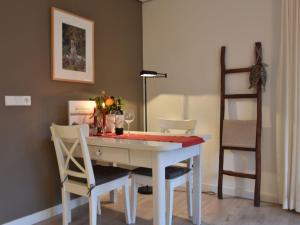 a dining room table with two chairs and a ladder at Apartment in Bergen near Sandy Beaches in Bergen