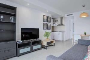 A television and/or entertainment centre at 4Greta Corralejo Apartment