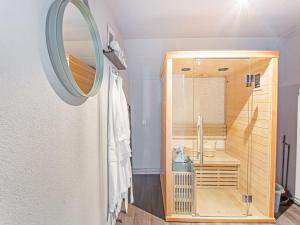 a bathroom with a tub and a sink and a mirror at Premium Farmhouse in Zelhem with Sauna in Zelhem
