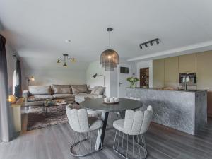 a kitchen and a living room with a table and chairs at Premium Farmhouse in Zelhem with Sauna in Zelhem