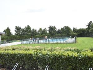 einen Pool in einem Park mit Menschen im Hintergrund in der Unterkunft Lush holiday villa at lovely location in Zeewolde in Zeewolde