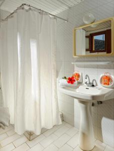 a bathroom with a white shower curtain and a sink at Stelios Residence Apartments in Malia