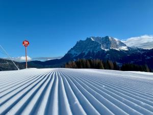 a snow covered slope with a mountain in the background at Das Wetterstein in Ehrwald