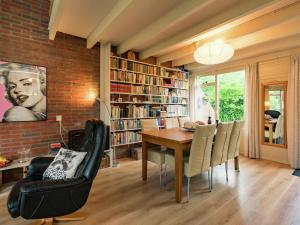 a dining room with a table and chairs and a brick wall at Cosy holiday home in Lauwersoog in Lauwersoog