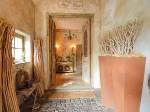 a hallway with a large vase in a room at Unique holiday home with a hot tub in Alphen