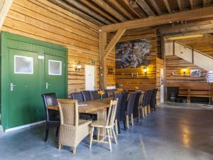 a dining room with a green door and a table and chairs at Charming Holiday Home near Beach in Meliskerke in Meliskerke