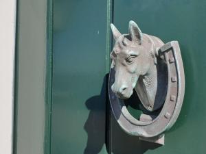 a metal horse head attached to a wall at Unique holiday home on Texel on the edge of Den Hoorn in Den Hoorn