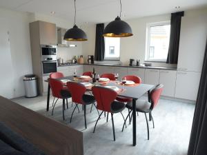 a kitchen and dining room with a table and chairs at Beautiful villa within National Park in Westermient