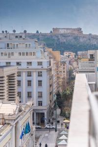 a view of a city with tall buildings and a castle at Rooftop apartment in the center of Athens in Athens
