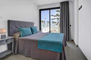 a bedroom with a bed and a large window at Seven Dreams Villas in Corralejo +19 photos