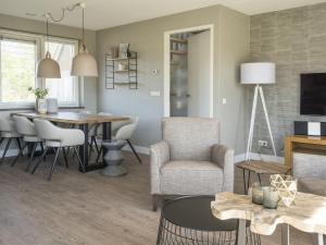 a living room and dining room with a table and chairs at Holiday Home in De Cocksdorp near Beach in De Cocksdorp