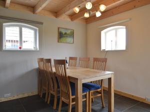 a dining room with a wooden table and chairs at Modern Holiday Home in Holten with Forest Near in Holten