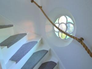 una escalera de caracol con una ventana circular en una casa en Modern Holiday Home in Haaksbergen with Garden, en Haaksbergen
